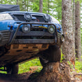 RalliTEK Subaru Forester Flexed onto Stump Showing off Skid Plate and Hidden Winch Mount