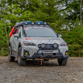 Off-road vehicle on a gravel path with trees in the background
