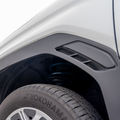 Close-up of a car's wheel well showing RalliTEK spring installed