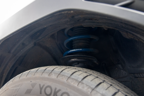 Close-up of a spring installed with RalliTEK branding, focusing on the spring installed on the strut assembly