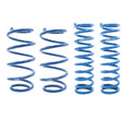 A set of blue coil springs for a vehicle suspension system, along with metal hardware components, displayed on a white background.